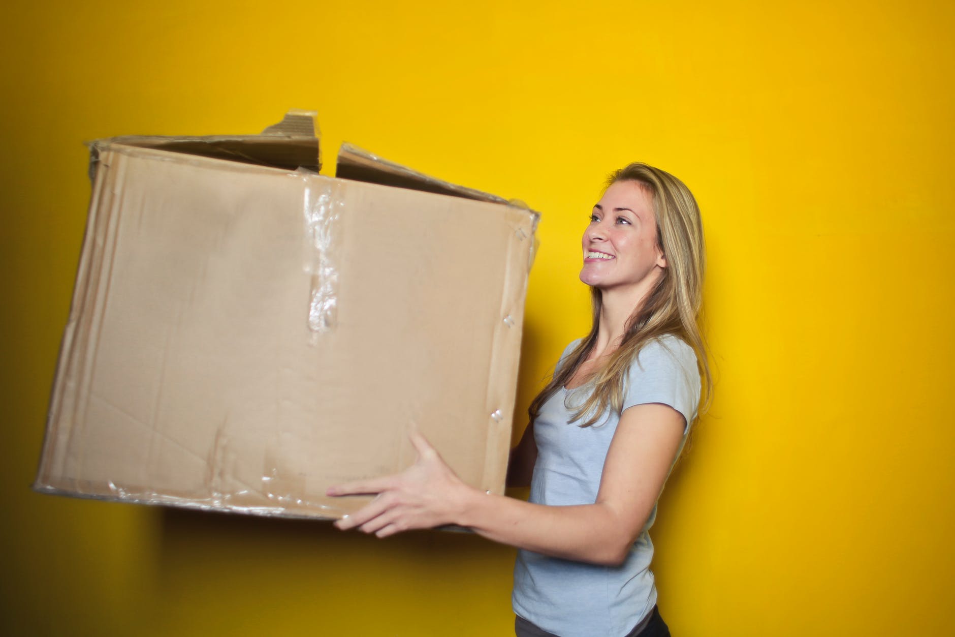 Woman carrying moving box