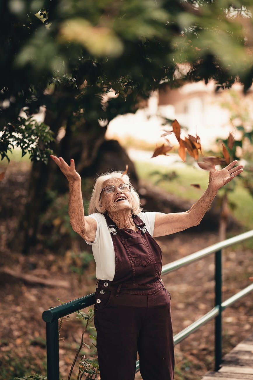 Woman throwing leaves in the air